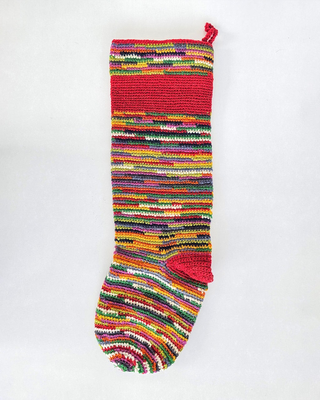 Handmade holiday tree stocking with striped cream base and bold striped pattern