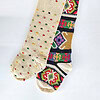Set of two handmade crochet Christmas stockings featuring multicolored polka dots and a vibrant tapestry-style woven pattern.