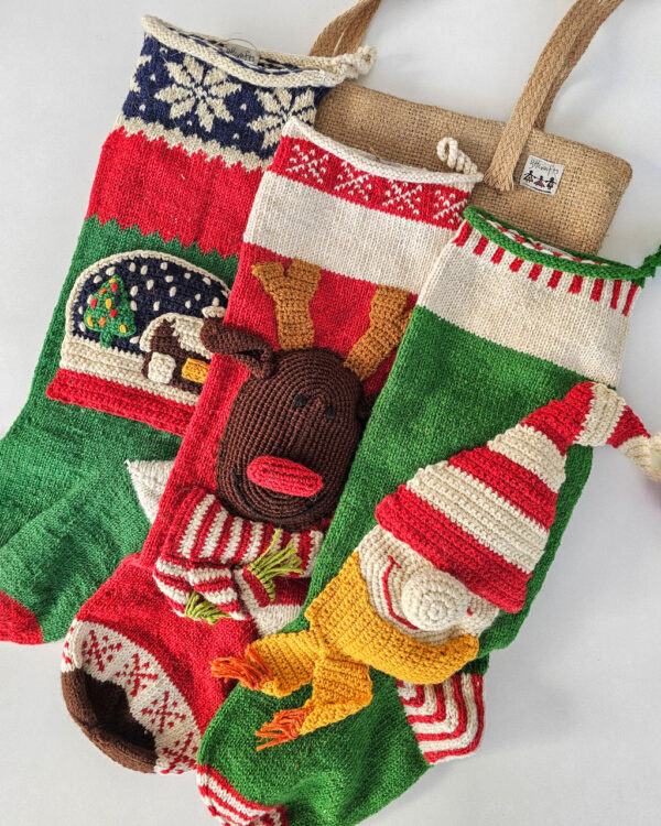 Handmade Christmas stockings with reindeer, elf, and snowball
