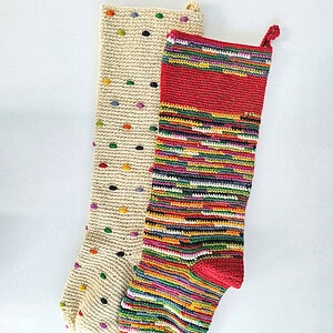 Handmade crocheted Christmas stockings in cream and multicolor stripes