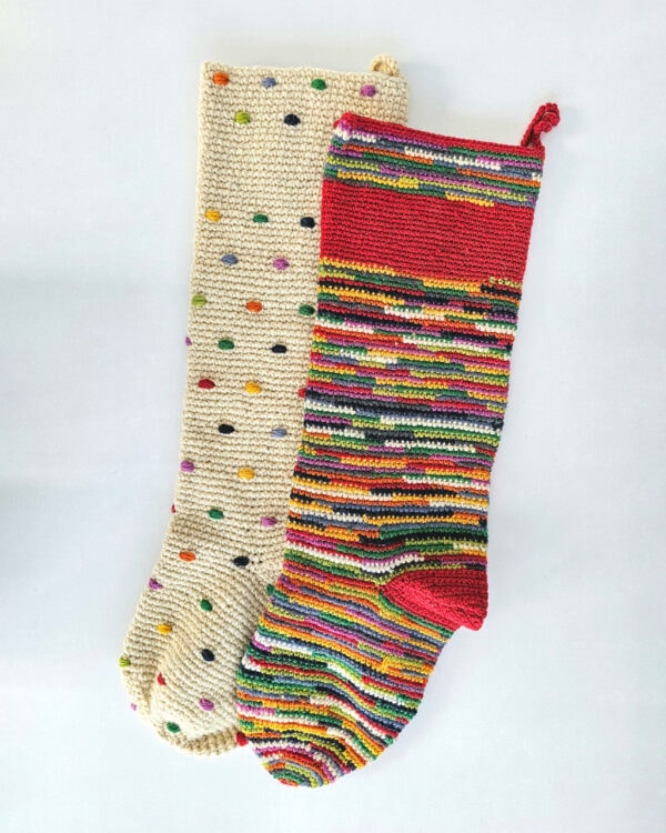 Handmade crocheted Christmas stockings in cream and multicolor stripes