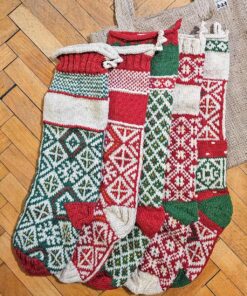 Five colorful knitted Christmas stockings with various pattern.