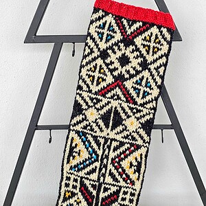 Hand knitted holiday stocking made of natural wool