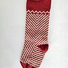 Fair trade artisanal Christmas stocking in red and cream zigzag knit design.