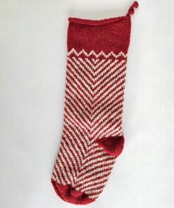 Fair trade artisanal Christmas stocking in red and cream zigzag knit design.