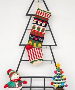 Fair-trade Christmas stocking featuring Santa, gifts, and bells in multicolor design.