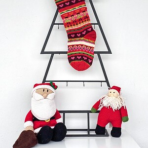 Hand knit Christmas stocking with colorful stripes and heart motifs, artisan made