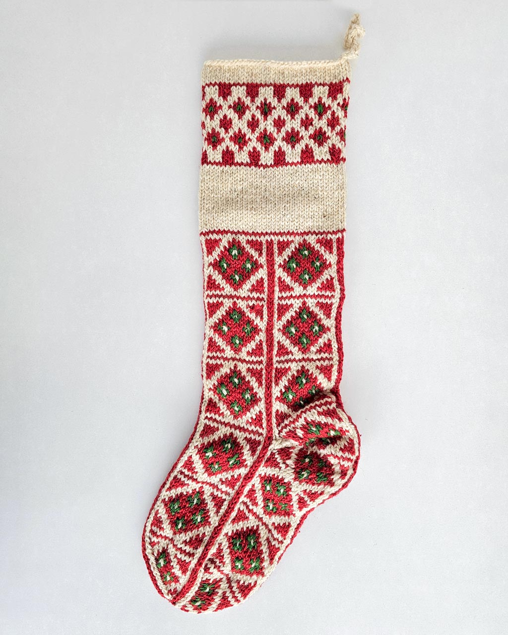 Red and green knit Christmas stocking with custom name