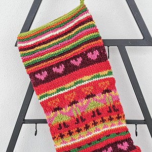Handmade knitted Christmas stocking with colorful Hearts and Stripes