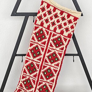 Jacquard hand-knitted red and white Christmas stocking with traditional pattern