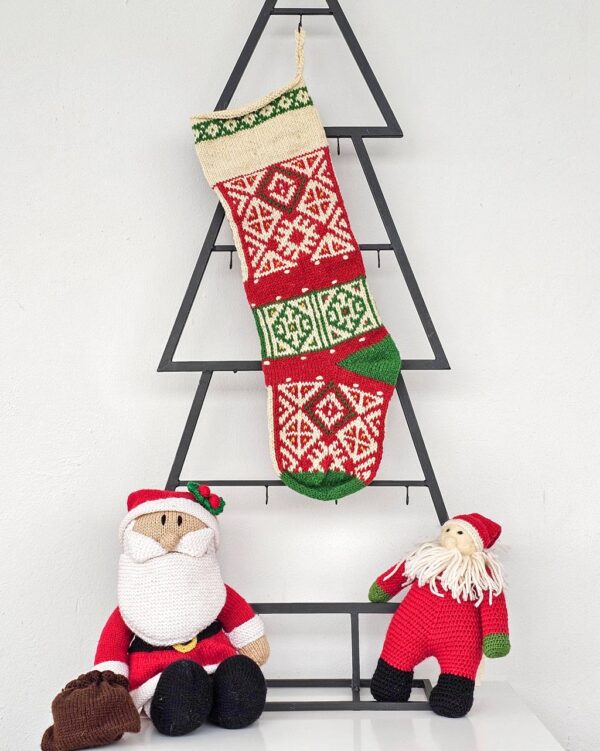Hand-knitted multicolor traditional Christmas stocking with rich pattern.