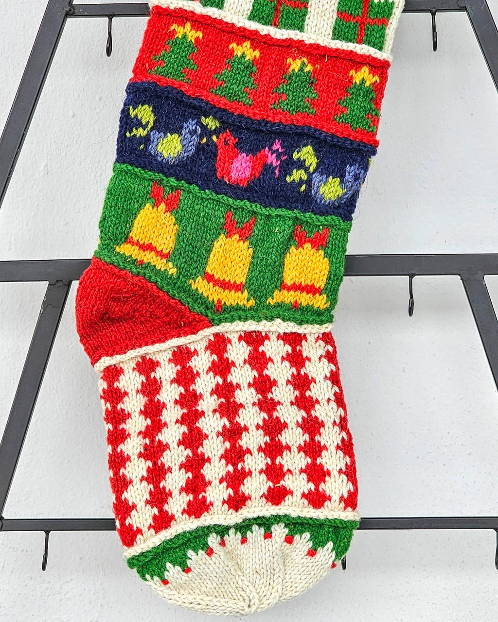 Close-up of heel section of a personalized hand-knitted Christmas stocking.