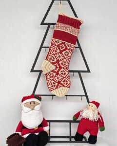 Hand-knitted red Christmas stocking with traditional Bosnian pattern, personalized name