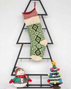 Personalized green knitted Christmas stocking with traditional Bosnian pattern