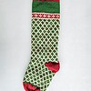 Personalized green knit Christmas stocking with red cuff and white diamond pattern, custom name on the cuff