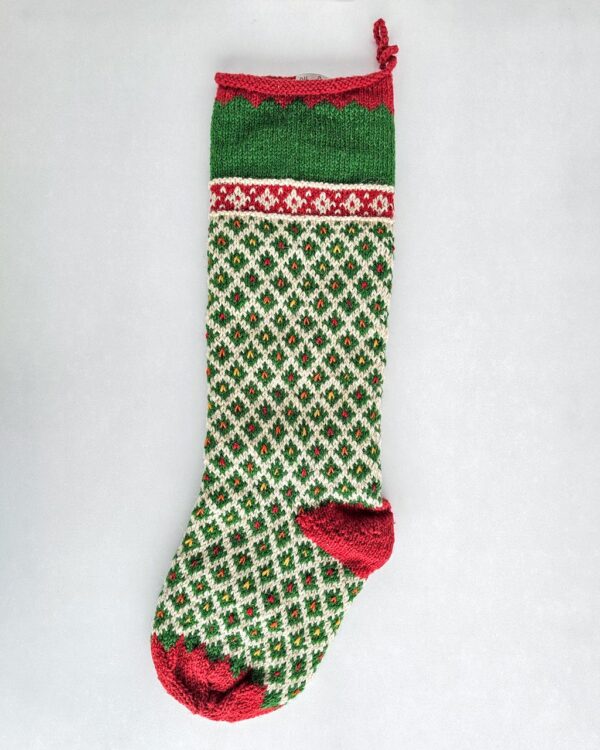 Personalized green knit Christmas stocking with red cuff and white diamond pattern, custom name on the cuff