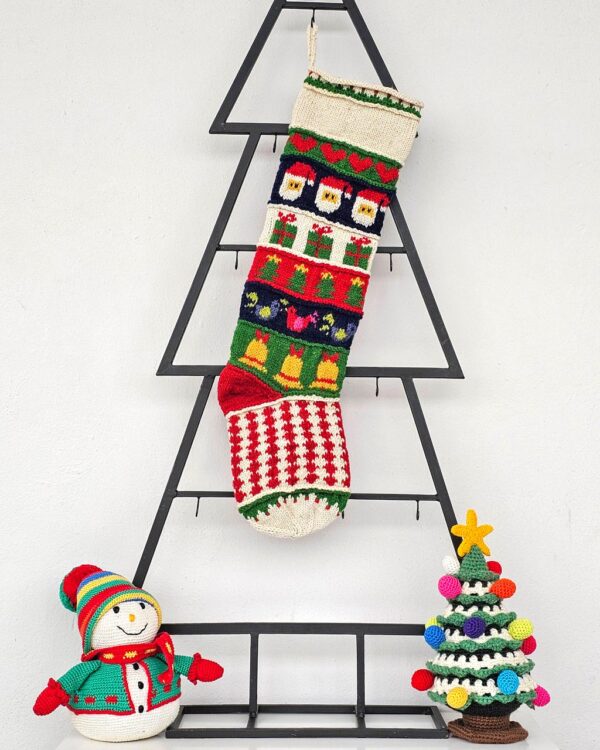Personalized hand-knitted Christmas stocking with Santa and gift patterns.