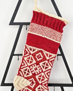 Hand-knitted red Christmas stocking with traditional pattern