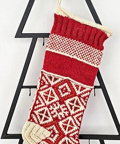 Hand-knitted red Christmas stocking with traditional pattern