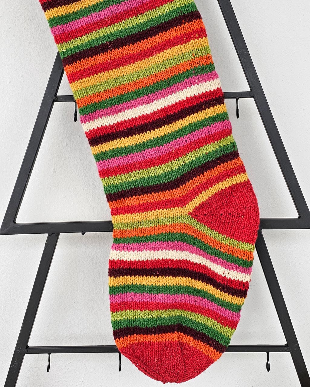 Multicolor striped holiday stocking, hand-knit in sustainable wool, 60×18 cm. Great addition to your Christmas home decor