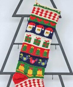 Close-up of top part of hand-knitted Christmas stocking with festive patterns.