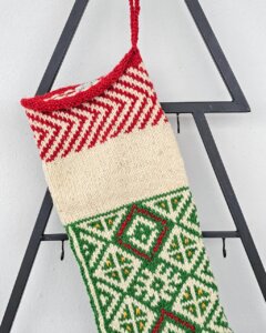 Top view of green Christmas stocking with custom name placement