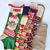 Five knitted Christmas stockings with various patterns.