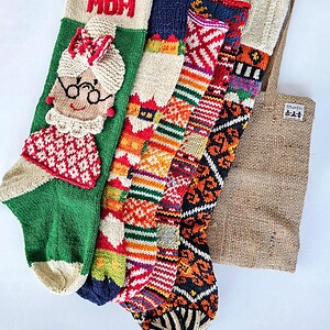 Five knitted Christmas stockings with various patterns.