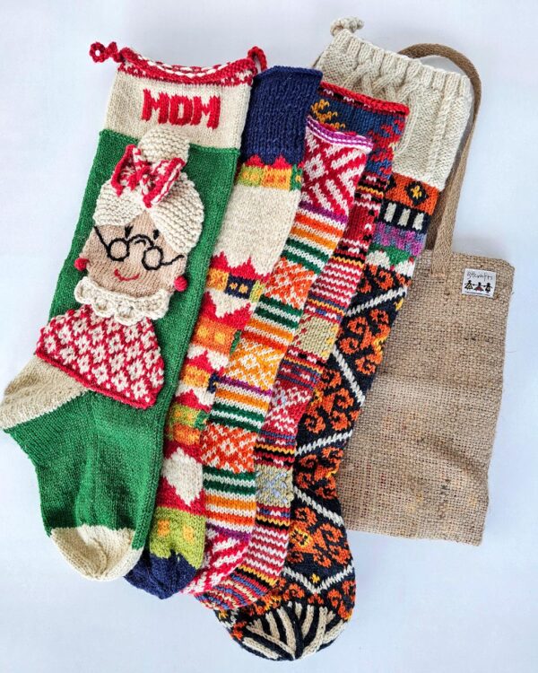 Five knitted Christmas stockings with various patterns.