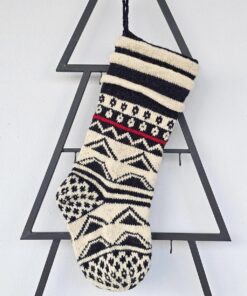 Black and white Christmas stocking hanging on a festive mantel