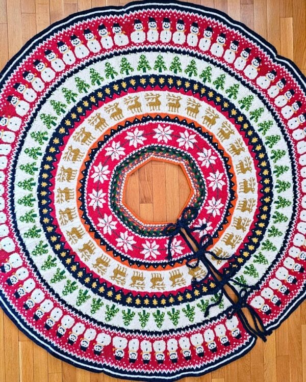 Festive tree skirt with snowmen and reindeer pattern